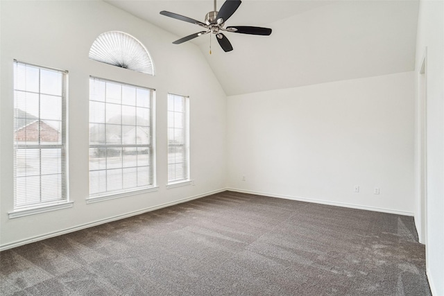 spare room with lofted ceiling, dark carpet, and ceiling fan