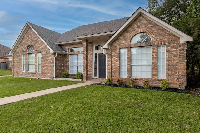 2324 Spring Mills Rd, Mesquite, TX 75181 - ranch-style home with a shingled roof, cooling unit, a front lawn, and brick siding
