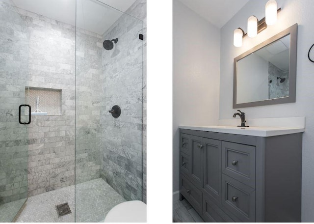 bathroom featuring vanity and a shower with door