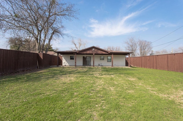 back of house featuring a lawn