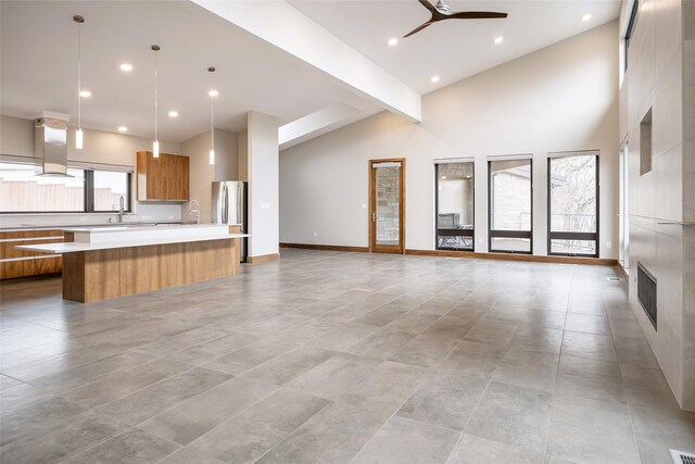 1621 Caddys Cir, Garland, TX 75043 - unfurnished living room with a ceiling fan, a sink, high vaulted ceiling, recessed lighting, and a large fireplace