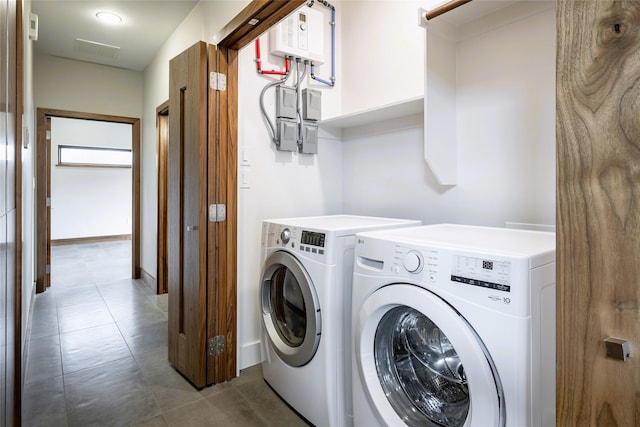 1621 Caddys Cir, Garland, TX 75043 - laundry area with washer and clothes dryer, water heater, and tile patterned floors