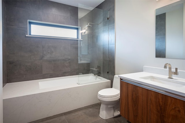 full bathroom featuring tiled shower / bath, vanity, tile patterned floors, and toilet