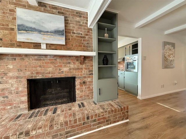 room details with oven, wood finished floors, baseboards, a brick fireplace, and beamed ceiling