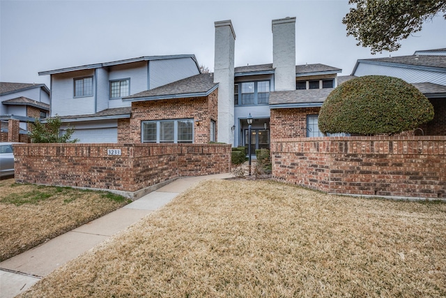 view of front facade with a garage and a front lawn