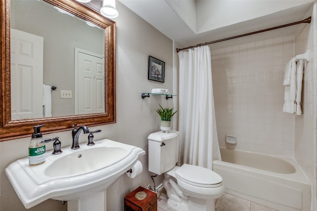 full bathroom with shower / tub combo, sink, tile patterned floors, and toilet