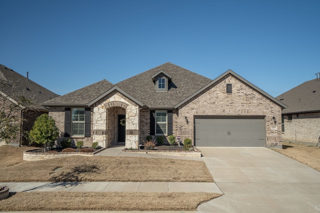 french country home with a garage