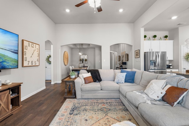 living room with ceiling fan and dark hardwood / wood-style flooring