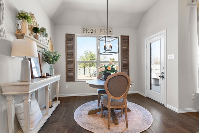 dining room featuring lofted ceiling, dark hardwood / wood-style floors, and a chandelier