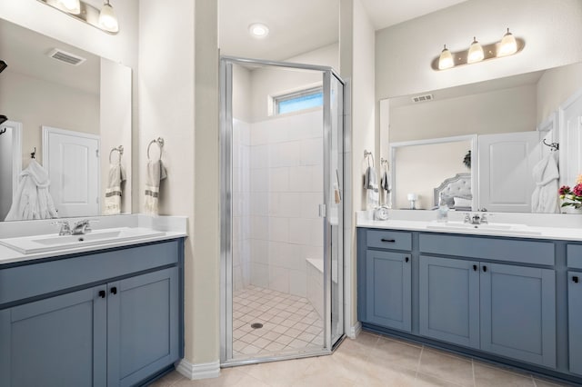 bathroom with vanity, tile patterned flooring, and walk in shower