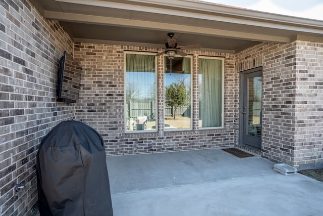 entrance to property with a patio and ceiling fan