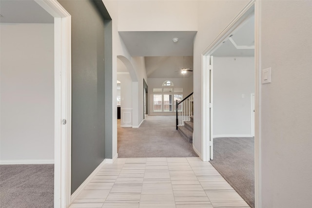 200 Ravenel St, Glenn Heights, TX 75154 - corridor with light carpet, arched walkways, stairs, and baseboards