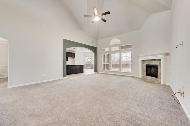 200 Ravenel St, Glenn Heights, TX 75154 - unfurnished living room with ceiling fan, high vaulted ceiling, arched walkways, light colored carpet, and baseboards