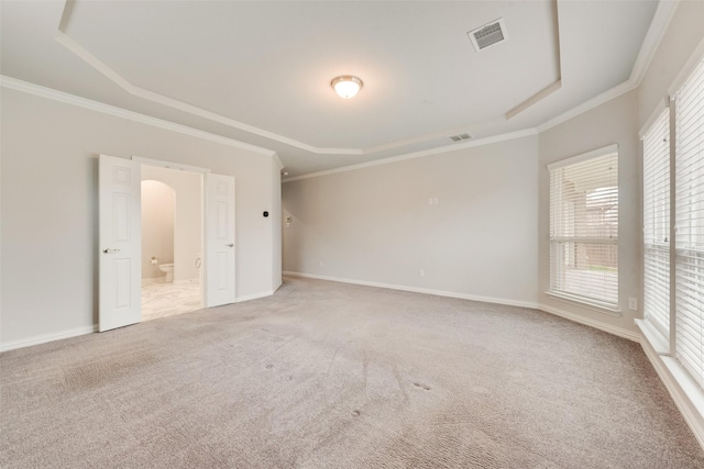 unfurnished bedroom featuring light colored carpet, ornamental molding, and a raised ceiling