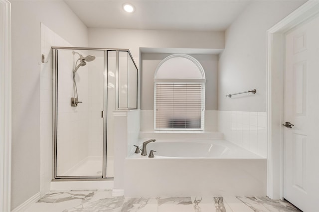 bathroom with separate shower and tub