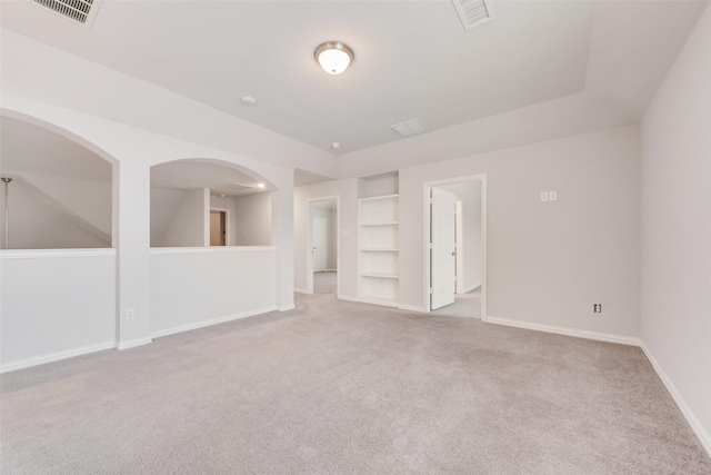 carpeted empty room featuring built in features