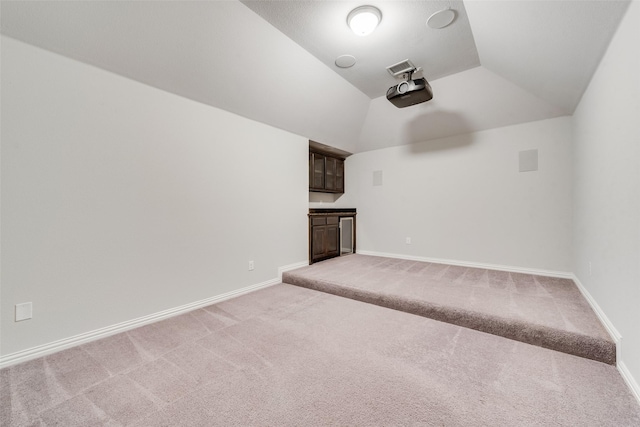 200 Ravenel St, Glenn Heights, TX 75154 - unfurnished living room featuring light carpet, vaulted ceiling, and baseboards