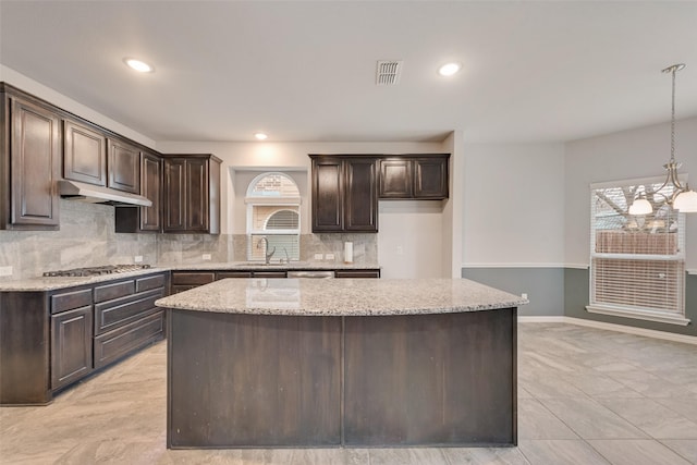200 Ravenel St, Glenn Heights, TX 75154 - kitchen with under cabinet range hood, a sink, healthy amount of natural light, dark brown cabinetry, and recessed lighting