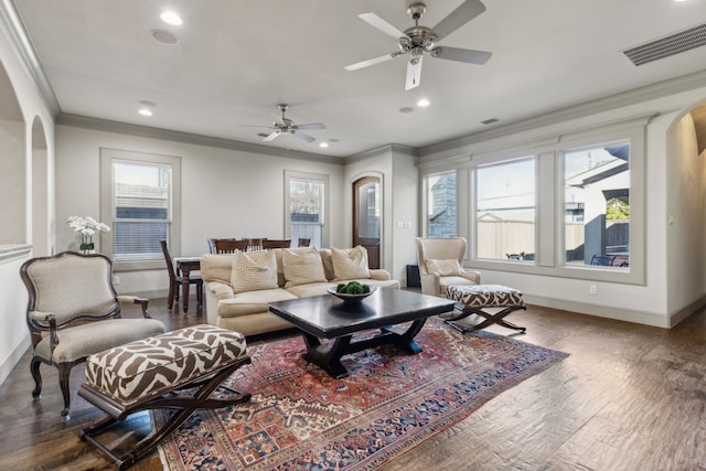 living room featuring dark hardwood / wood-style flooring and crown molding