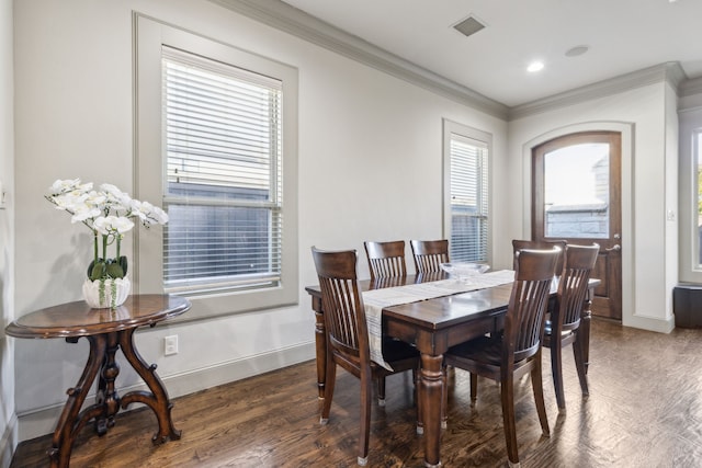 dining area with ornamental molding, a healthy amount of sunlight, and dark hardwood / wood-style flooring