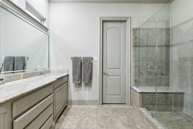 bathroom with vanity and a shower with shower door