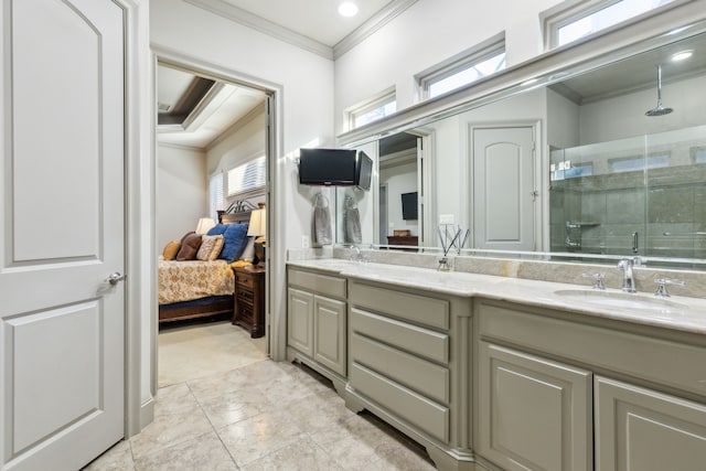 bathroom featuring vanity, a shower with door, and ornamental molding