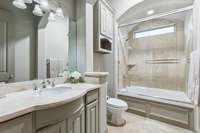 full bathroom featuring enclosed tub / shower combo, vanity, tile patterned floors, and toilet