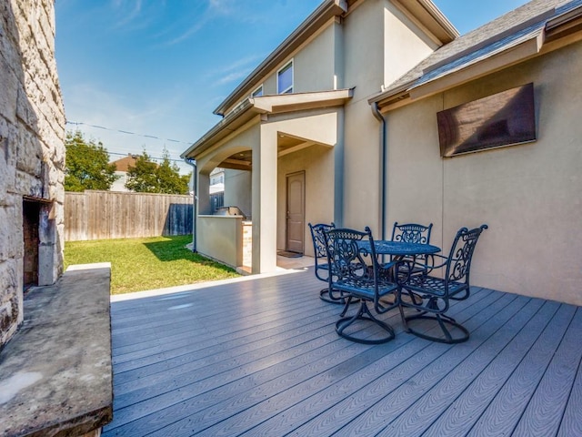 deck with area for grilling and a lawn