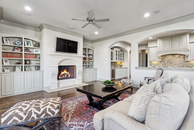 living room featuring dark hardwood / wood-style flooring, ornamental molding, beverage cooler, and ceiling fan