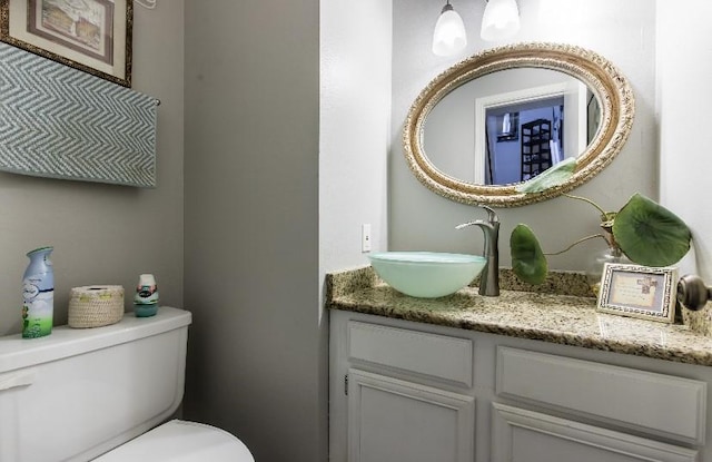 bathroom featuring vanity and toilet