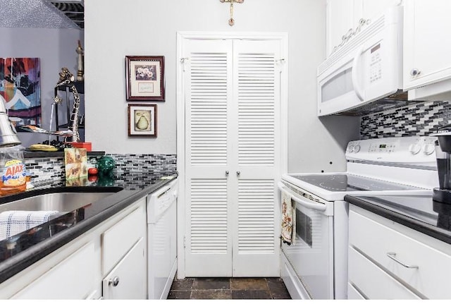 kitchen with tasteful backsplash, white appliances, and white cabinets