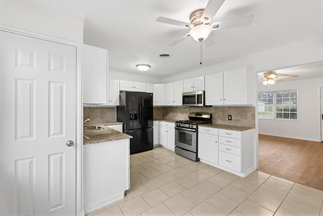 kitchen featuring ceiling fan, decorative backsplash, stainless steel appliances, and white cabinets