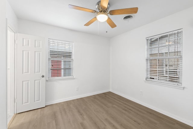 empty room featuring ceiling fan and light wood-type flooring