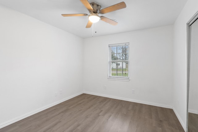 spare room with ceiling fan and wood-type flooring