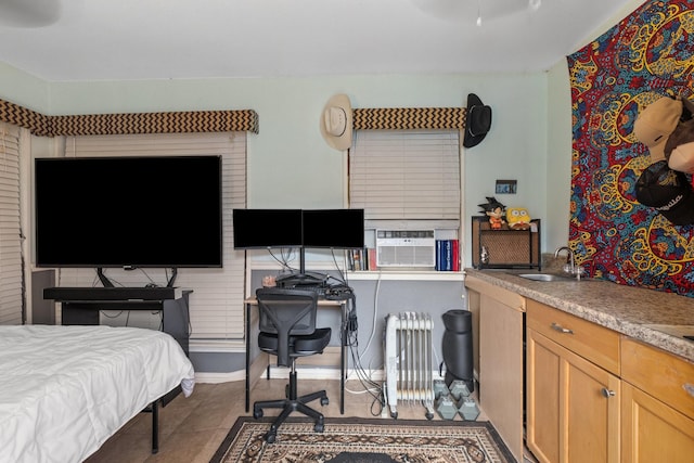 tiled bedroom with cooling unit, radiator, and sink