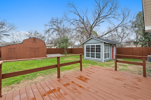 wooden deck featuring a yard and a shed