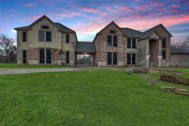 view of front of home featuring a lawn and a carport