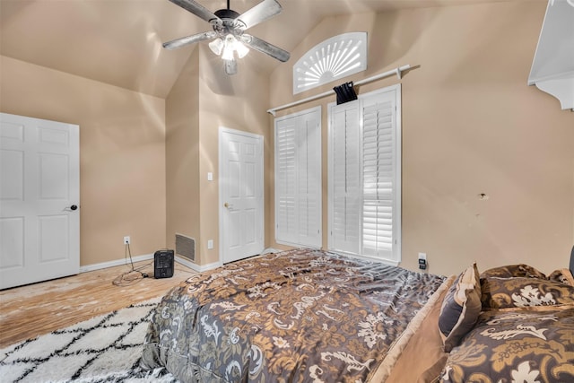 bedroom featuring hardwood / wood-style flooring, vaulted ceiling, and ceiling fan