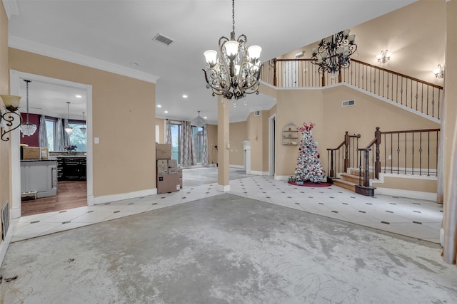 interior space featuring an inviting chandelier, ornamental molding, a high ceiling, and a wealth of natural light