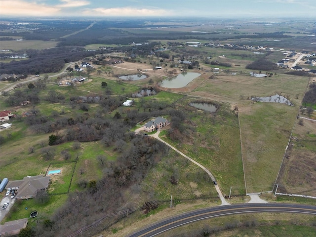 drone / aerial view featuring a water view and a rural view