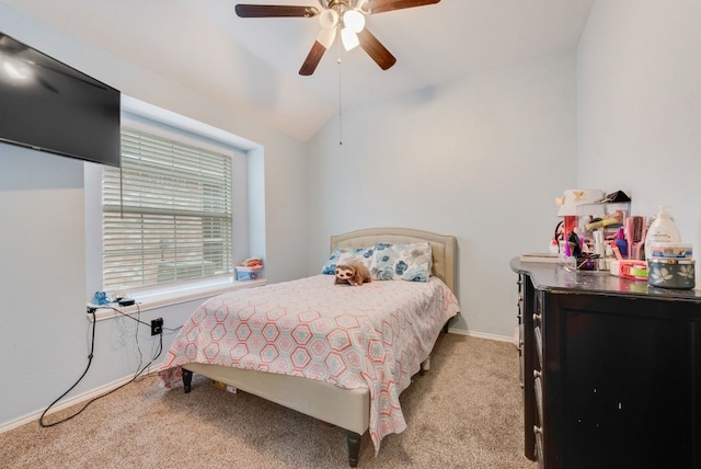 carpeted bedroom with vaulted ceiling and ceiling fan