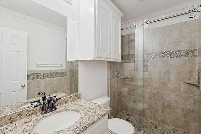 bathroom featuring a shower with door, vanity, crown molding, and toilet