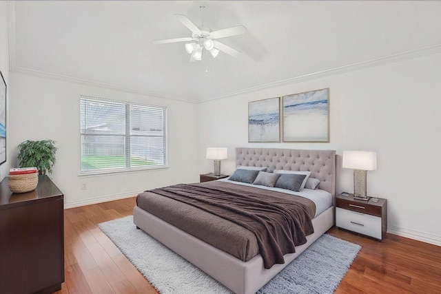 bedroom featuring ceiling fan, ornamental molding, and hardwood / wood-style floors