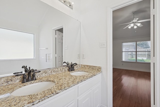 bathroom with vanity, ceiling fan, vaulted ceiling, and wood-type flooring