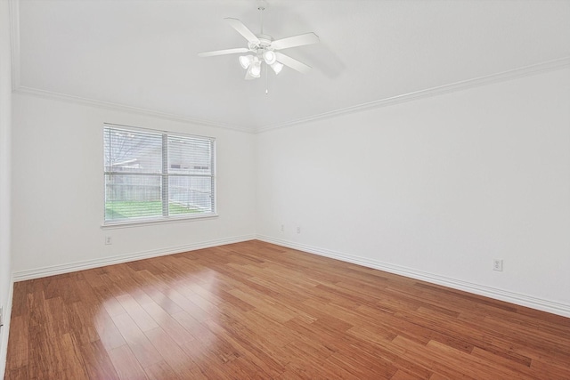 empty room featuring crown molding, wood-type flooring, and ceiling fan