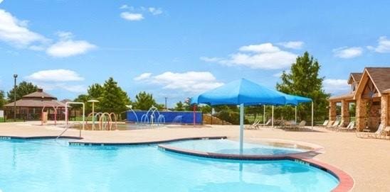 view of swimming pool featuring a hot tub, a gazebo, and a patio