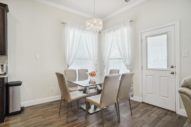 dining space featuring crown molding and a chandelier