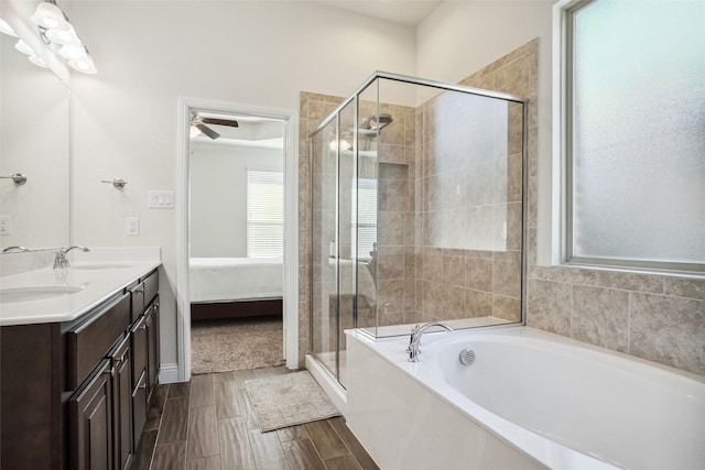 bathroom with hardwood / wood-style flooring, shower with separate bathtub, and vanity