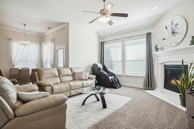 carpeted living room with ornamental molding and ceiling fan