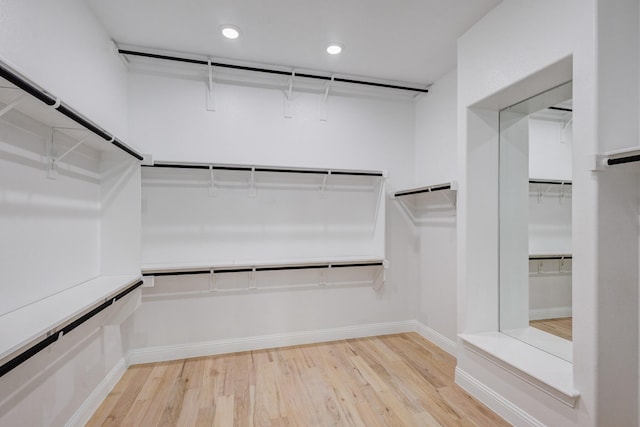 spacious closet with light hardwood / wood-style floors